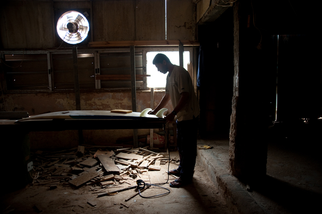 Gaza, Al Hindi Ashour in his workshop, where he repairs surfboards