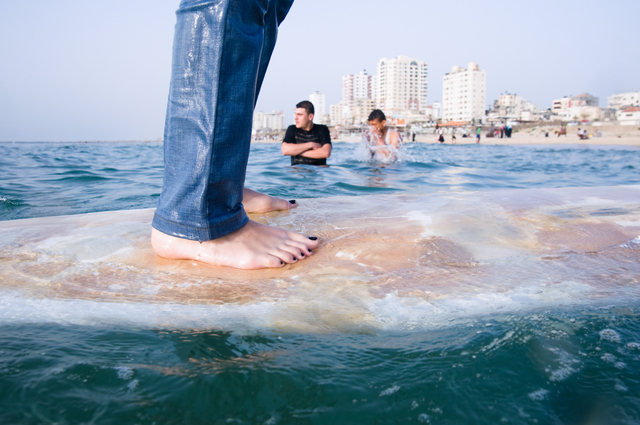 Gaza City, young surfer Shorouq Abu Ghanem, 14, in front of the Annadi Al Bahri Marine Club.