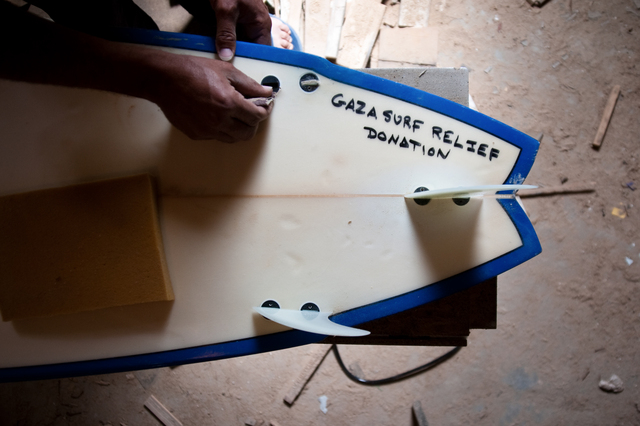 Gaza, Al Hindi Ashour in his workshop, where he repairs surfboards