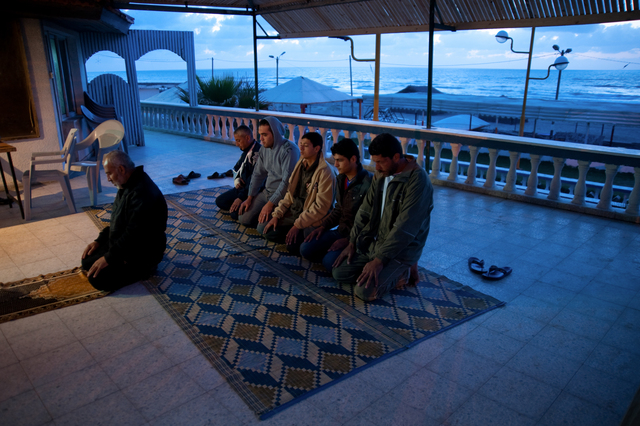 Gaza, surfers and non-surfers praying in the Annadi Al Bahri Marine Club