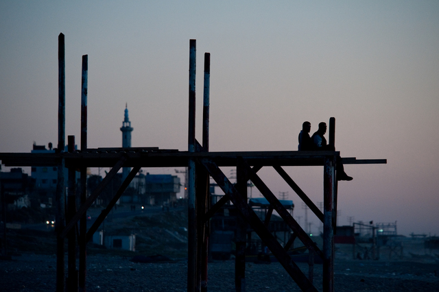Gaza, surfers observing the sea from the lifeguard's lookout (being renovated) at the Annadi Al Bahri Marine Club