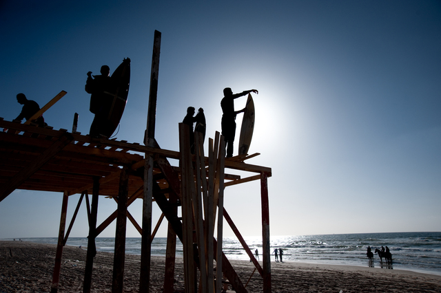 Gaza, surfers observing the sea from the lifeguard's lookout (being renovated) at the Annadi Al Bahri Marine Club
