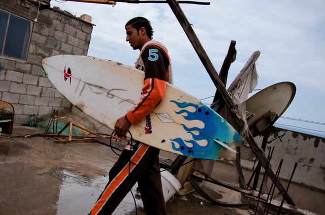 Gaza, Mahmoud Osama Al-Rayashi at home, on the roof where he keeps his surfboards