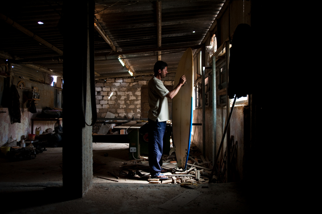 Gaza, Al Hindi Ashour in his workshop, where he repairs surfboards