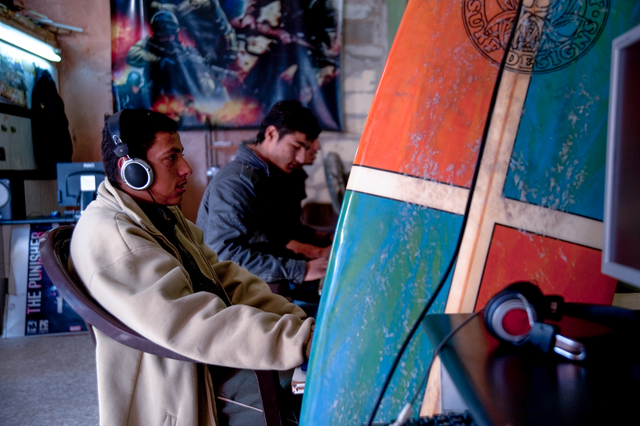 Gaza, Yosef Abu Ghanem, Ibrahim Arafat and Mahmoud Osama Al-Rayashi in an internet café near the beach