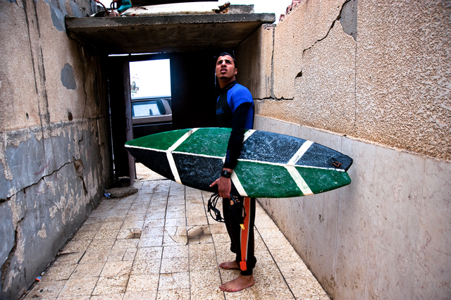Gaza, Al Hindi Ashour speaks with young Yosef Abu Ghanem before entering the water