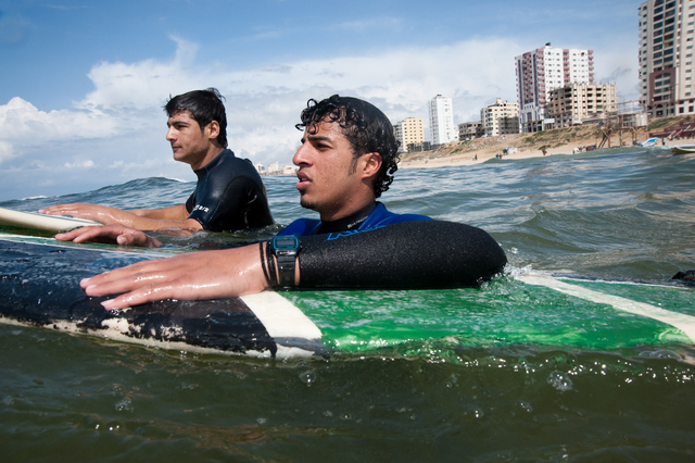 Gaza, Mahmoud Osama Al-Rayashi and Ibrahim Arafat wait for the perfect wave