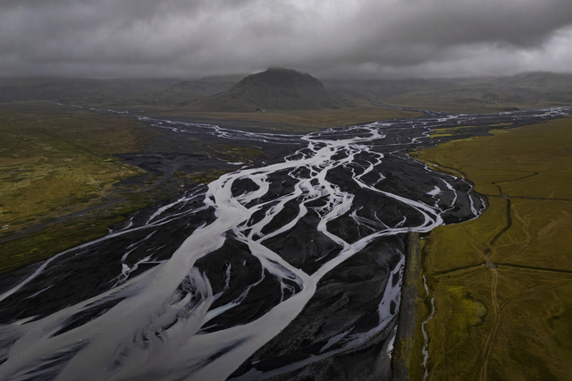 Hringvegur (Iceland): a wide river flows down to the sea from the Mýrdalsjökull glacier, Iceland’s fourth-largest ice cap, which covers the active Katla volcano beneath it. One in three foreigners in Iceland lives outside the Reykjavík metropolitan area, working mainly in tourism, fishing and agriculture.