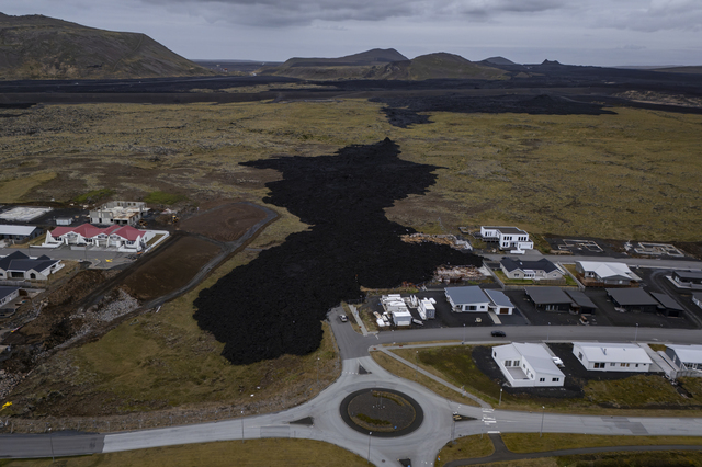Grindavik (Iceland): the solidified black lava that erupted from a volcanic fissure on 14 January 2024 and flowed towards the village, destroying three houses (the remains of the homes can still be seen). No members of the three families lost their lives. Grindavik has for years been home to a significant number of migrant workers, particularly in the fish processing industry.